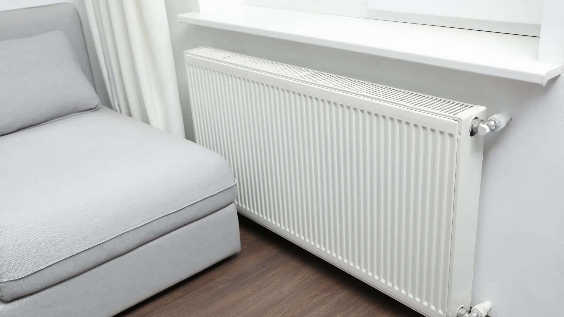 Panel radiator fitted under a window on a balanced central heating system