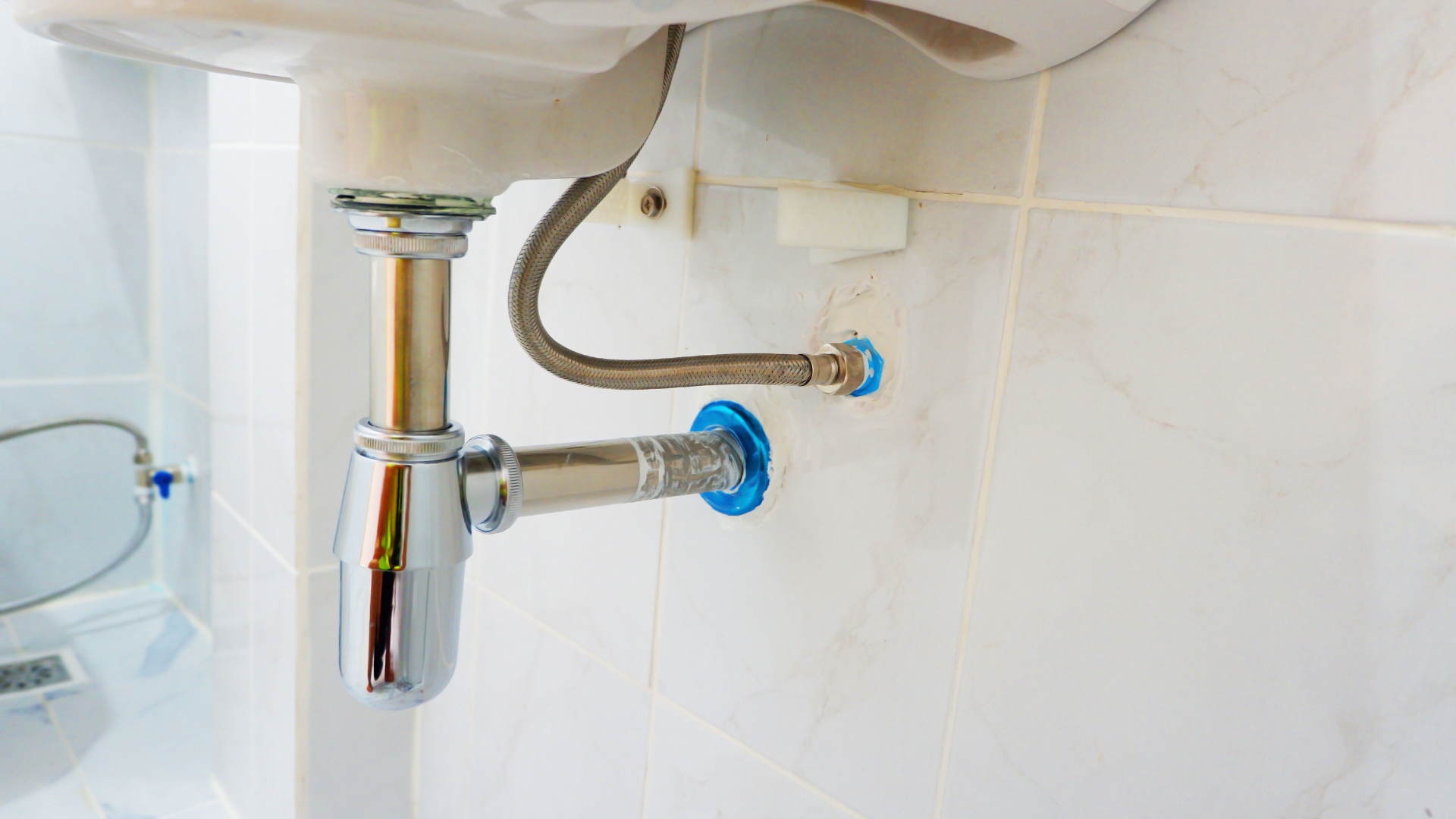 New chrome sink trap and flexible supply connection fitted by a Liverpool plumber